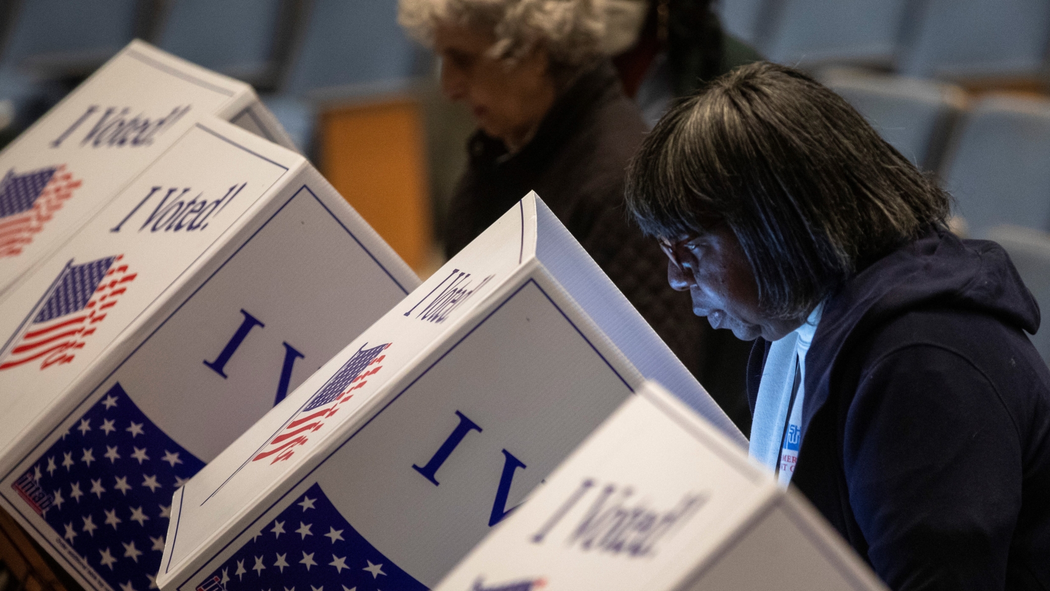 Voters at a voting booth.